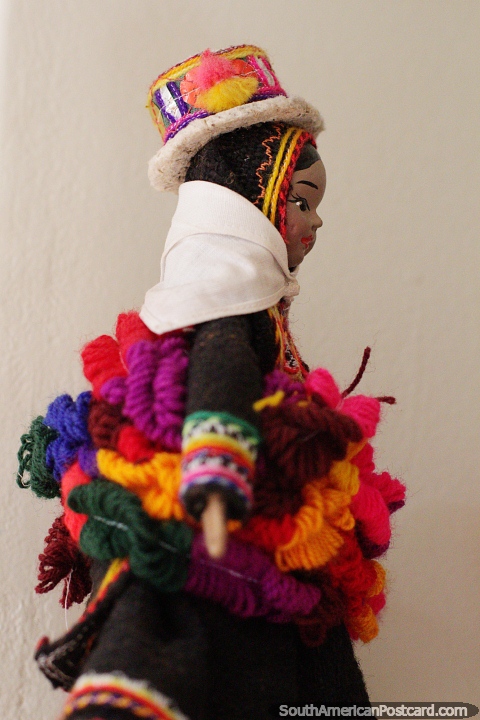 Alpaca wool dyed in many colors keeps the indigenous people warm, female doll at the Carlos Dreyer Museum, Puno. (480x720px). Peru, South America.