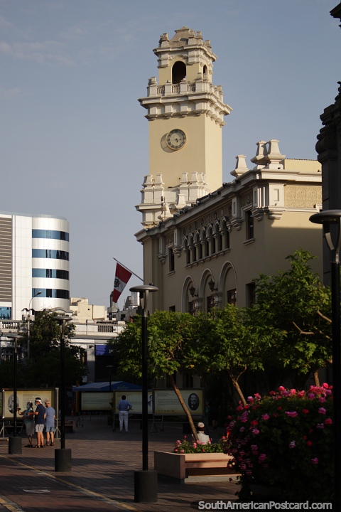 Clock tower and building on the corner of Kennedy Park in Lima, beside the church. (480x720px). Peru, South America.