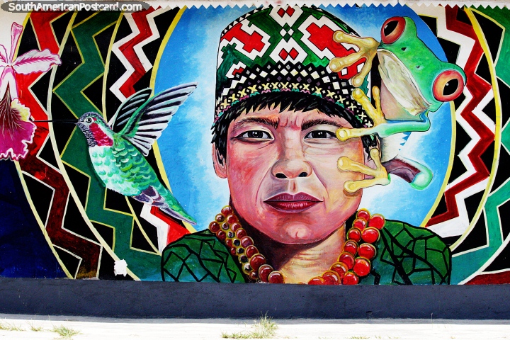 Man wearing traditional headgear and clothes, a frog and hummingbird, Moyobamba street art. (720x480px). Peru, South America.