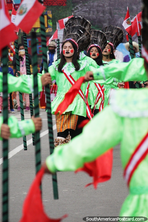 Young ladies in lime green costumes, red dots and feathered headgear perform in Chota. (480x720px). Peru, South America.
