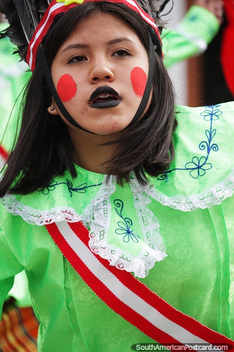 Young lady with large red dots painted on her face, street show in Chota. (480x720px). Peru, South America.