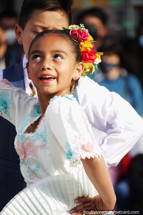 With a bouquet of flowers in her hair, a young lady performs in Chota. (480x720px). Peru, South America.