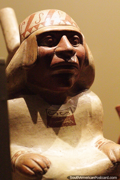 Man with beady eyes and head wear, ceramic work, Sipan museum, Lambayeque. (480x720px). Peru, South America.