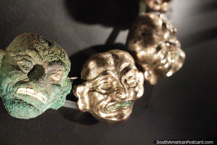 Metal necklace with the faces of death, green one is as found, others cleaned, Sipan museum, Lambayeque. (720x480px). Peru, South America.