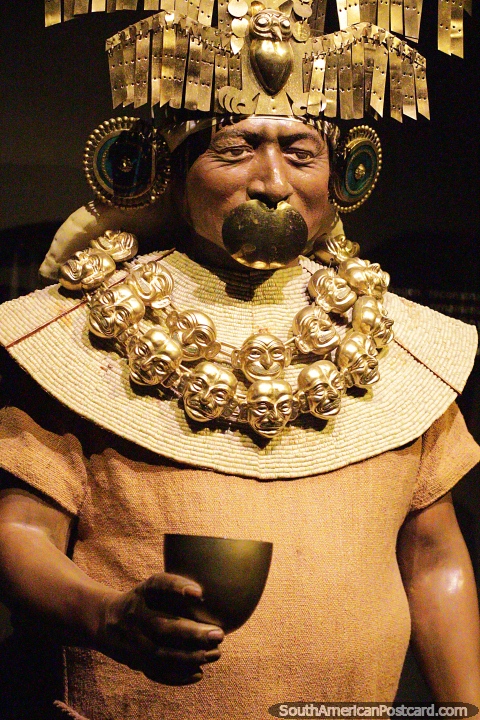 Moche priest with ornaments around his neck and a drink vessel, Sipan museum, Lambayeque. (480x720px). Peru, South America.