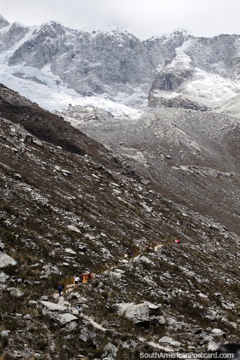 Snow and ice on the peak above the pathway to the lookout over Paron Lagoon, Caraz. (480x720px). Peru, South America.