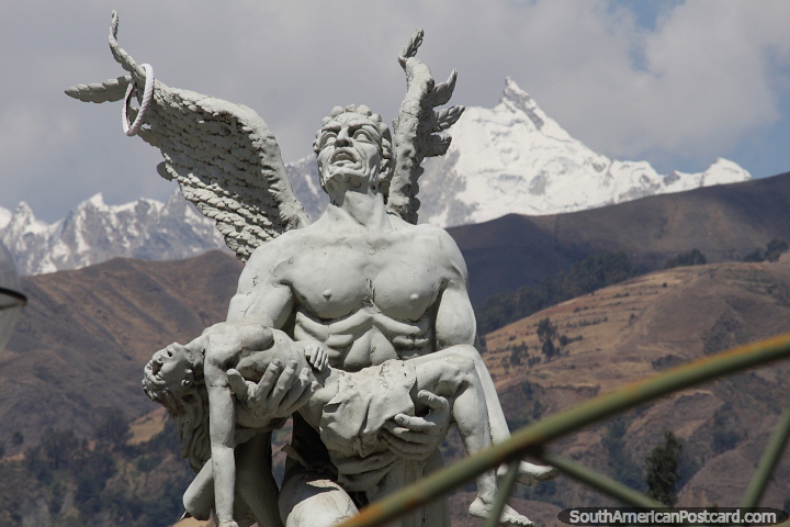 Angel rescues a lady, monument at the park in Huaraz, snow-capped mountains behind. (720x480px). Peru, South America.
