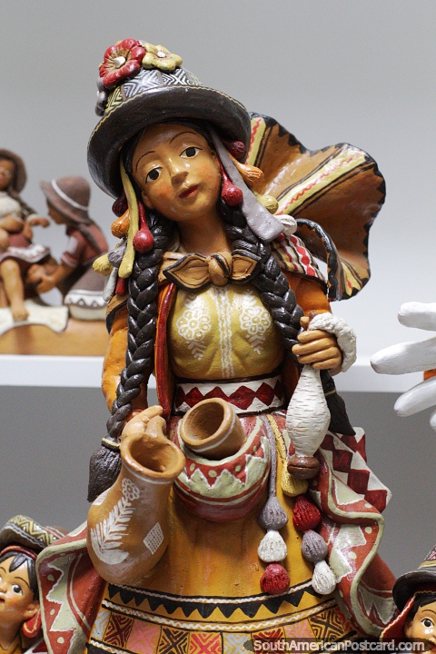 Woman carrying urns, great ceramic work at the crafts center in Ayacucho. (480x720px). Peru, South America.