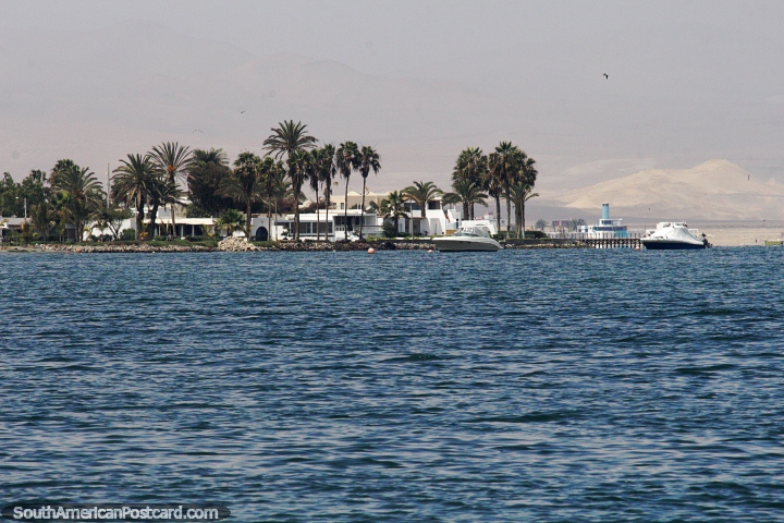 Luxury properties and boats on the coast in Paracas, deep blue seas. (720x480px). Peru, South America.