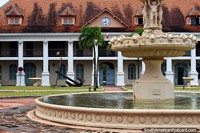 Clock, anchor, fountain, columns, red tiled roof, the Prefecture in Cayenne in French Guiana.