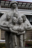 A figure holds 5 children, monument in Paramaribo, Suriname. The 3 Guianas, South America.