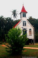 A small old red and white church above the ground in the Coronie district between Paramaribo and Nickerie, Suriname.