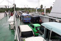 Larger version of Ferry loaded up with vehicles and people, leaving South Drain in Suriname for Moleson Creek, Guyana.