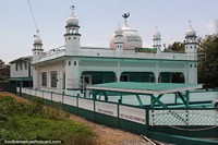 Larger version of Nur-E-Islam Mosque with white dome around Moleson Creek in Guyana.