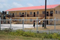 A school and kids in the yard in a community between New Amsterdam and Georgetown, Guyana. The 3 Guianas, South America.
