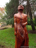 Man looking to the sky, wooden sculpture at Plaza San Martin in Colon. Argentina, South America.