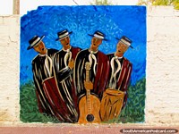 4 well-dressed musicians in hats sing a song, wall mural in Cafayate.