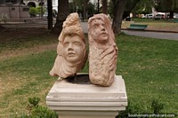 2 faces carved out of rock, a work of art displayed in the main plaza in Salta.