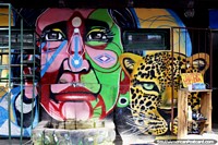 Face of a tiger and man, street art in El Bolson.