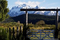 Around Los Cipreses, farm gate and mountains near the border of Argentina and Chile. Argentina, South America.