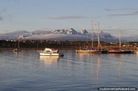 Calm waters in the bay in the morning and boats docked in Ushuaia. Argentina, South America.