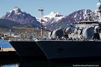Navy ships with colorful flags with the Martial mountain ranges behind in Ushuaia. Argentina, South America.