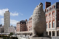 Sea lion monument and towering buildings on the waterfront in Mar del Plata. Argentina, South America.