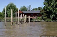 Large wooden house and newly built jetty beside the river in Tigre, Buenos Aires. Argentina, South America.