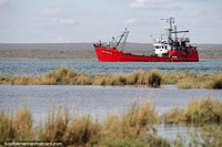 Big red ship Don Agustin passes through the harbor in San Antonio Oeste. Argentina, South America.