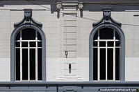 Pair of arched windows of the historic bank building in Trelew. Argentina, South America.
