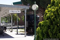 Original train station in Trelew with black train, clock and sign. Argentina, South America.