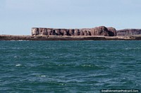 Great rock formation, like a tabletop, an island in Puerto Deseado. Argentina, South America.