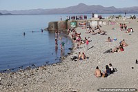 Stony beach at the lake in Bariloche is popular in December. Argentina, South America.