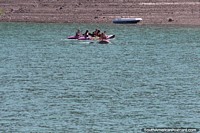 People kayaking in 2 person kayaks at Valle Grande Reservoir, San Rafael.
