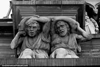 Stonework of 2 men holding up the Church of the Capuchins in Cordoba. Argentina, South America.