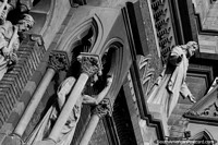 Religious figures and the intricate facade of the Church of the Capuchins in Cordoba.