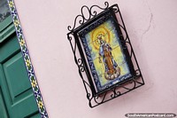 Tile mural of Our Lady Carmen in an iron frame in Goya.