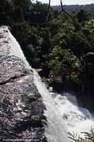 Waterfalls pounding over the rock cliffs at Iguazu Falls.