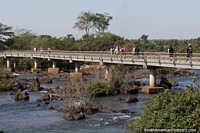 Walking bridge over the river to see all the waterfalls at Puerto Iguazu. Argentina, South America.