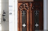 Decorative faces sculpted on a wooden door in Jujuy, antique.