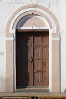 Larger version of Wooden doorway with ceramic decoration around it in Santa Cruz.