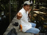 Local man catches a piranha in Rurrenabaque. Bolivia, South America.