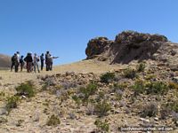Guide explains about the rocks on Isla del Sol, Lake Titicaca.
