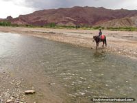 Many rivers to cross on the horse riding tour in Tupiza. Bolivia, South America.