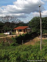 Small house, car and power pole in the country south of Santa Cruz. Bolivia, South America.