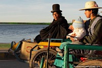 A woman dressed in black gets a ride across the bridge at Desaguadero. Bolivia, South America.