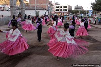 Bolivia Photo - Women in pink and white, men in purple and black, locals dancing in Desaguadero.