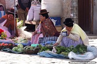 3 women sit beside the road selling some basic vegetables in La Paz. Bolivia, South America.