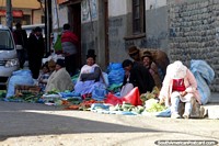 Bolivia Photo - Women sit together and sell vegetables at the road-side in La Paz.