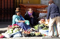 This woman is happy to have an early customer to sell some vegetables to, Mercado Rodriguez, La Paz. Bolivia, South America.